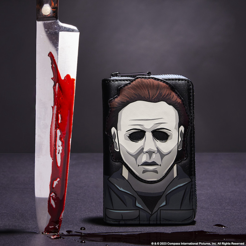 Image of our Michael Myers Wallet sitting next to a large kitchen knife covered in fake blood